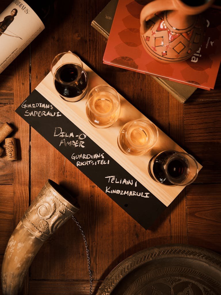 Explore a selection of Georgian wines elegantly presented on a tasting flight in a cozy restaurant setting.